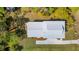 An aerial view showcasing a home with a gray roof, complemented by lush landscaping and a concrete driveway at 3683 Nassas St, Mount Pleasant, SC 29466