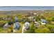 Expansive aerial view of a coastal home nestled among lush greenery, offering serene water views in the distance at 3683 Nassas St, Mount Pleasant, SC 29466