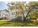 Elegant two-story home surrounded by mature trees, featuring double porches for relaxing outdoor living at 3683 Nassas St, Mount Pleasant, SC 29466