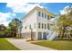 Striking two-story home with a light exterior, dual porches, and pristine landscaping for enhanced curb appeal at 3683 Nassas St, Mount Pleasant, SC 29466
