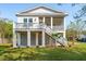 Beautiful two-story white home with screened porch, deck and white stairs at 3683 Nassas St, Mount Pleasant, SC 29466