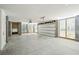 Garage with concrete floor, garage door and wood slat walls leading to outside area at 3683 Nassas St, Mount Pleasant, SC 29466