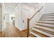 Hallway with hardwood floors, white trim, and staircase with wood railing at 3683 Nassas St, Mount Pleasant, SC 29466