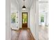 Bright entryway boasting hardwood floors, white trim, stylish lighting, and an inviting view into adjacent rooms at 3683 Nassas St, Mount Pleasant, SC 29466