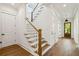 Hallway with hardwood floors, white trim, and staircase with wood railing at 3683 Nassas St, Mount Pleasant, SC 29466