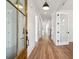 Elegant entryway featuring gleaming hardwood floors, white walls, and stylish glass-paneled doors for a modern touch at 3683 Nassas St, Mount Pleasant, SC 29466