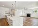 Open kitchen featuring a large island with modern fixtures, white cabinets, and hardwood floors at 3683 Nassas St, Mount Pleasant, SC 29466