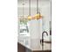 Close-up of kitchen island with pendant lights and black faucet; bright, window-lit background at 3683 Nassas St, Mount Pleasant, SC 29466