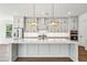 Well-lit kitchen showcasing gray cabinetry, modern appliances, and a large island with stylish lighting at 3683 Nassas St, Mount Pleasant, SC 29466