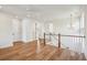 Bright second floor landing boasting hardwood floors and stylish chandelier lighting at 3683 Nassas St, Mount Pleasant, SC 29466