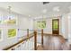 Bright landing boasts hardwood floors, natural light, and stylish chandelier lighting at 3683 Nassas St, Mount Pleasant, SC 29466