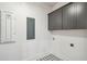 Well lit laundry room with patterned tile floor and gray cabinets at 3683 Nassas St, Mount Pleasant, SC 29466