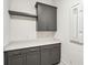 Laundry room featuring gray cabinets, a bright white countertop, and patterned tile floor at 3683 Nassas St, Mount Pleasant, SC 29466