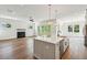 Open-concept living room and kitchen with hardwood floors, fireplace, and modern fixtures at 3683 Nassas St, Mount Pleasant, SC 29466