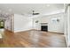Bright living room featuring hardwood floors, white walls, a fireplace, and modern ceiling fan at 3683 Nassas St, Mount Pleasant, SC 29466