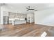 Open-concept living space with hardwood floors and kitchen with grey cabinets and island at 3683 Nassas St, Mount Pleasant, SC 29466