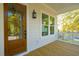 Welcoming porch with wood floors, a wooden door, and a hanging lantern, perfect for relaxing and enjoying the outdoors at 3683 Nassas St, Mount Pleasant, SC 29466