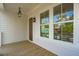 Charming porch with a wooden floor, large windows, and a stylish hanging lantern, creating a warm welcome at 3683 Nassas St, Mount Pleasant, SC 29466