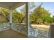 Inviting porch with wooden floors and railings, offering a serene outdoor living space overlooking lush greenery at 3683 Nassas St, Mount Pleasant, SC 29466
