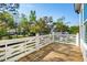 Open air porch with white wood railing offers a beautiful outdoor space overlooking the green space at 3683 Nassas St, Mount Pleasant, SC 29466