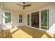 Covered porch with ceiling fan and windows, features sliding glass door into the main living area at 3683 Nassas St, Mount Pleasant, SC 29466