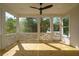 Inviting screened porch with wood flooring, ceiling fan, and views of the surrounding trees at 3683 Nassas St, Mount Pleasant, SC 29466