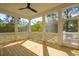 Enjoy the outdoors from this spacious screened porch with wood flooring and ceiling fan at 3683 Nassas St, Mount Pleasant, SC 29466