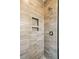 Tiled shower stall featuring horizontally laid tiles, niche, and chrome fixtures at 3683 Nassas St, Mount Pleasant, SC 29466