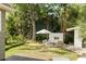 Inviting backyard with outdoor fireplace, seating area, lush landscaping, and a charming umbrella at 40 Dunnemann Ave, Charleston, SC 29403