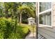 Lush backyard featuring a seating area with an outdoor fireplace, surrounded by greenery and mature trees at 40 Dunnemann Ave, Charleston, SC 29403
