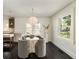 Bright dining room with view to the kitchen, a modern chandelier and large windows at 40 Dunnemann Ave, Charleston, SC 29403
