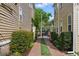 Backyard walkway with lush greenery on either side, leading to a gate for added privacy and security at 44 Savage St, Charleston, SC 29401