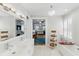 Bright bathroom with double vanity, soaking tub, shelving, and a peek into the main bedroom at 44 Savage St, Charleston, SC 29401