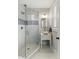 Updated bathroom with a glass enclosed shower, vessel sink, updated vanity, and a bright window for natural light at 44 Savage St, Charleston, SC 29401