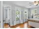 Sunlit bedroom with folding glass doors, hardwood floors, natural light, and tranquil view creating a peaceful retreat at 44 Savage St, Charleston, SC 29401