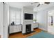 Bedroom featuring a fireplace, TV, shuttered windows, and a view into the large walk-in closet at 44 Savage St, Charleston, SC 29401
