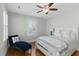Bright bedroom features hardwood floors, a ceiling fan, and a blue chaise lounge at 44 Savage St, Charleston, SC 29401