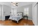 Comfortable bedroom with a queen bed, hardwood floors, stylish decor, and bright windows offering plenty of sunlight at 44 Savage St, Charleston, SC 29401