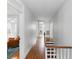 Hallway with wood flooring, white walls, and stairs with white railing and wood treads at 44 Savage St, Charleston, SC 29401