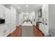 Spacious kitchen with an island, stainless steel appliances, white cabinetry, and hardwood floors offers a modern and functional space at 44 Savage St, Charleston, SC 29401