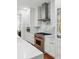 Well-appointed kitchen featuring stainless steel appliances, white cabinets, a marble backsplash, and hardwood floors for a modern touch at 44 Savage St, Charleston, SC 29401
