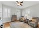 Bright living room with hardwood floors, ceiling fan, and accent chairs perfect for relaxing and entertaining guests at 44 Savage St, Charleston, SC 29401