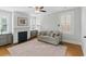 Cozy living room with a fireplace, neutral sofa, and shuttered windows providing ample natural light at 44 Savage St, Charleston, SC 29401