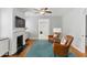 Bright living room with a fireplace, TV, two leather chairs, and a glimpse into the all-white bathroom at 44 Savage St, Charleston, SC 29401