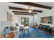Cozy living room with exposed wood beams, comfortable seating, a stylish rug, and abundant natural light creates a warm and inviting space at 44 Savage St, Charleston, SC 29401