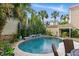 Lush backyard pool area featuring a uniquely shaped pool, mature landscaping, and inviting outdoor seating at 44 Savage St, Charleston, SC 29401