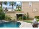 Beautiful backyard pool area with inviting lounge chair, lush landscaping, and charming pool house at 44 Savage St, Charleston, SC 29401
