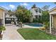 Inviting backyard pool with stone waterfall, landscaping, patio furniture, and grill area for outdoor entertaining at 44 Savage St, Charleston, SC 29401