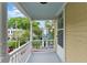 Porch with white railing, view of street, trees, and neighboring houses at 44 Savage St, Charleston, SC 29401