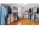 Walk-in closet with ample storage, custom shelving, and a window with shutters at 44 Savage St, Charleston, SC 29401